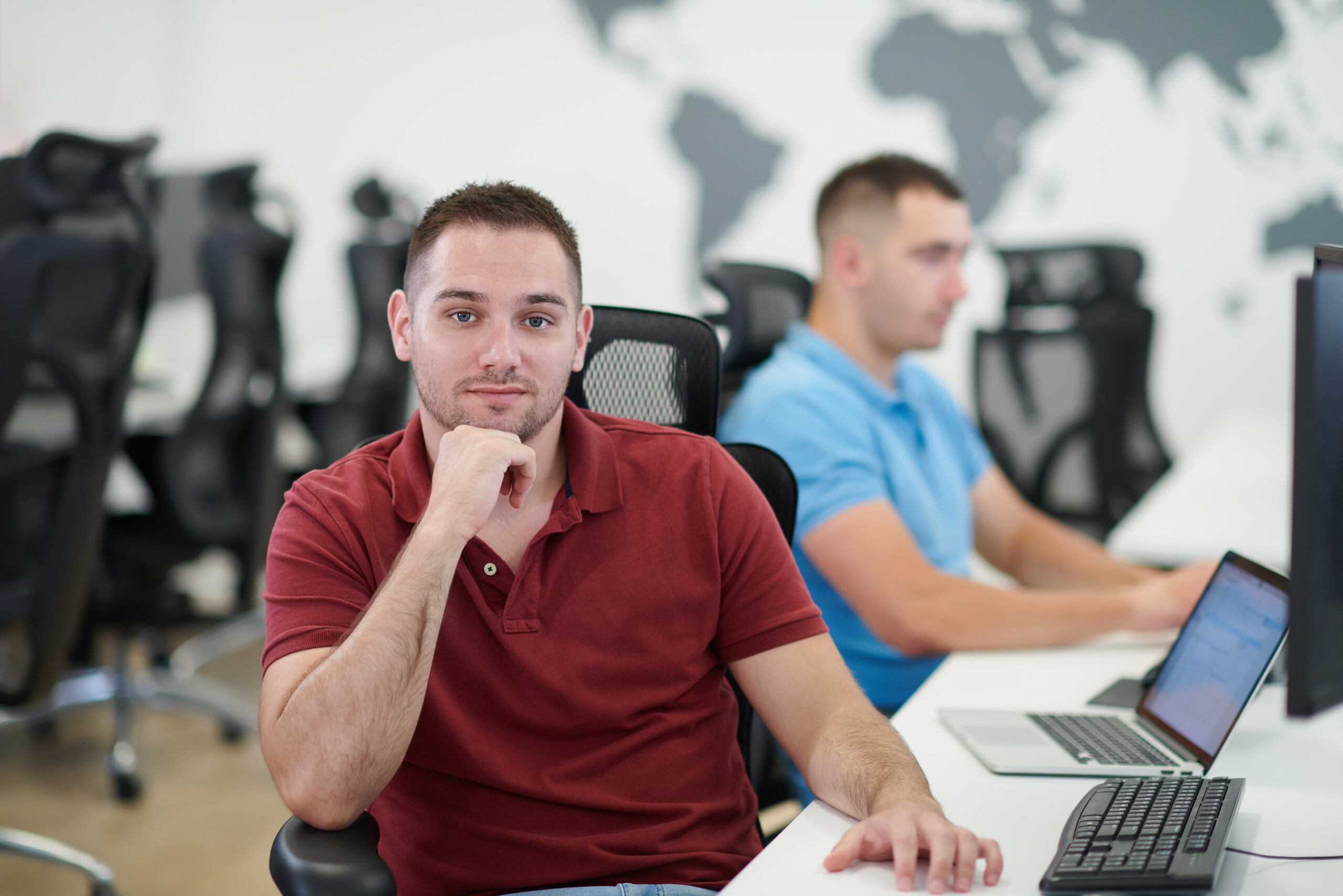two male software developers working on computer